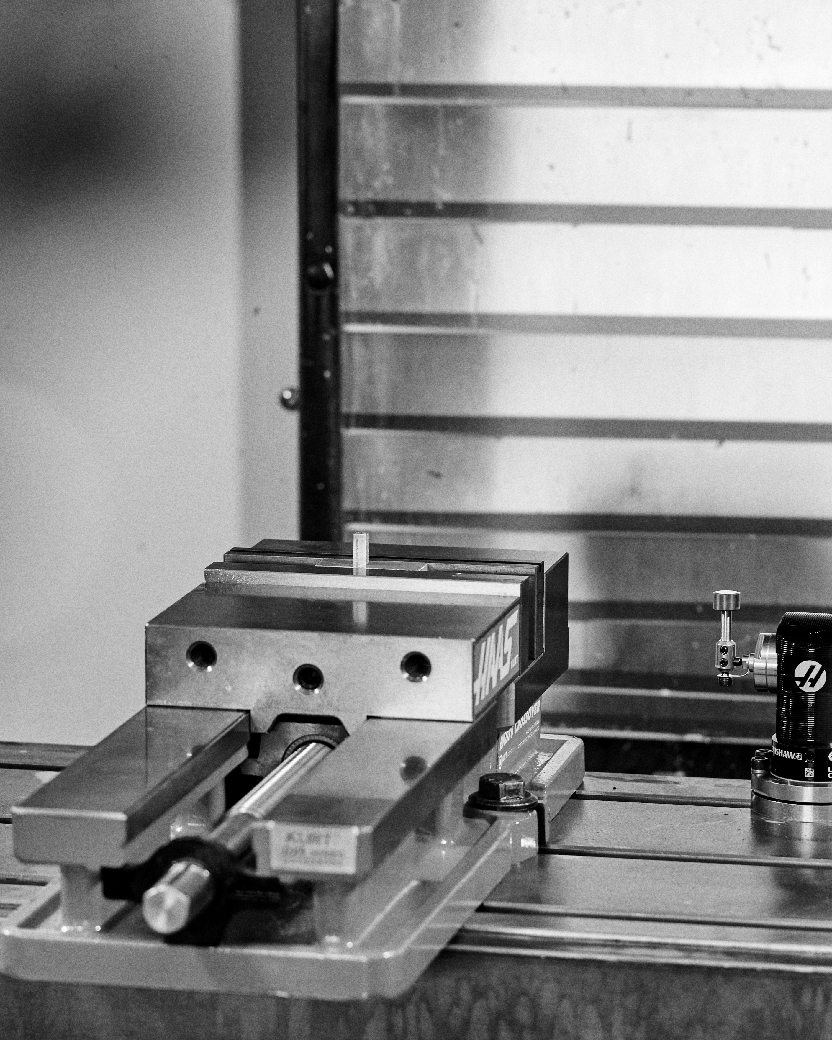 Black & White Close-up of a HAAS machine tool with a RESS Jewellery block in the vice. 